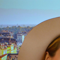 smiling traveler portrait city hat